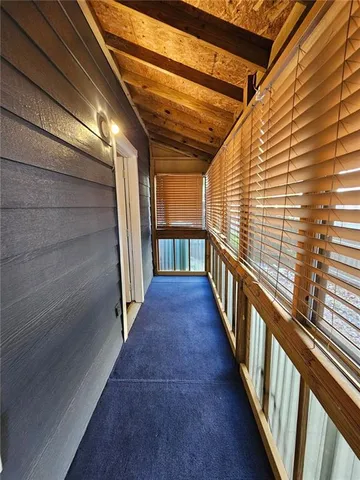 a view of a porch with wooden floor and stairs