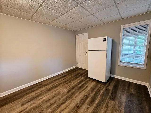 a view of a room with wooden floor and white walls