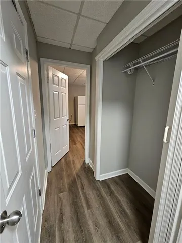 a view of a hallway with wooden floor