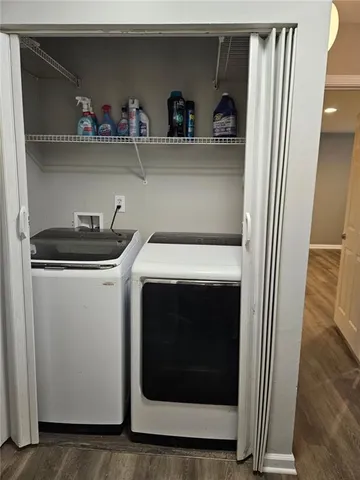 a utility room with sink dryer and washer