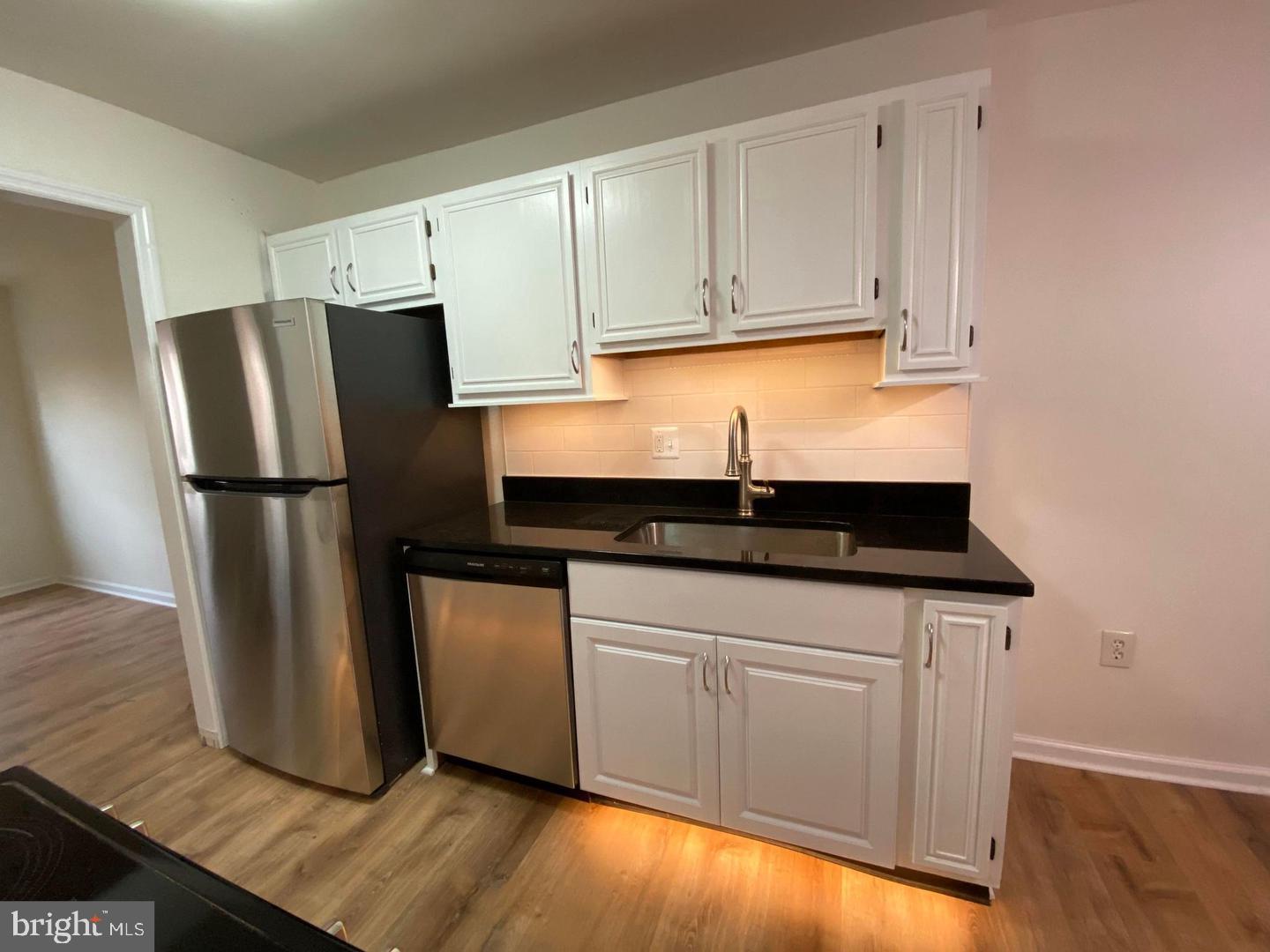 14 Vienna Court Frederick, MD 21702 - Photo 2 of 9 a kitchen with granite countertop a refrigerator sink and cabinets