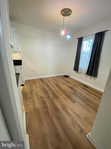 a view of an empty room with a mirror