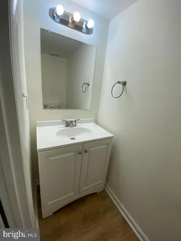 a bathroom with a sink vanity and a mirror