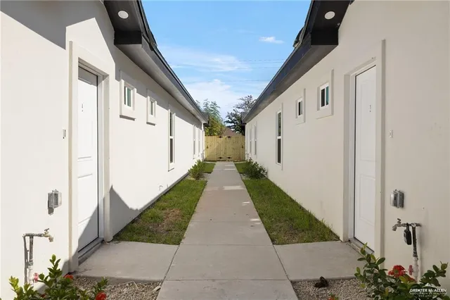 a view of a pathway both side of house