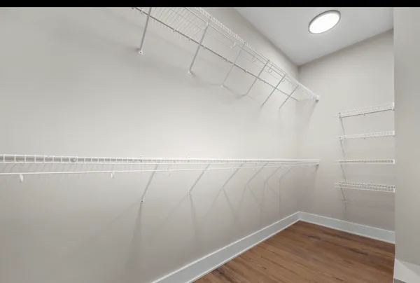 a view of a room with wooden floor
