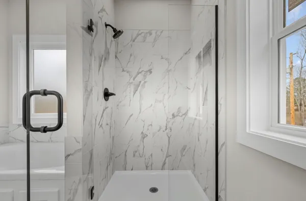 a bathroom with a shower and a sink