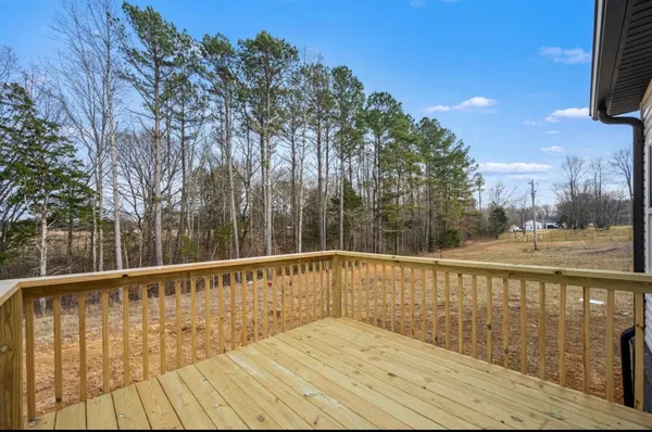 a view of balcony with wooden floor and fence