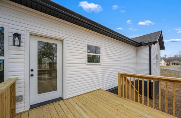 a view of a house with wooden deck
