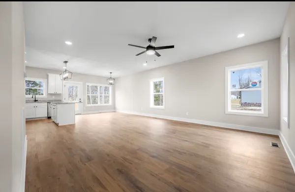 a view of a livingroom with furniture wooden floor and a window