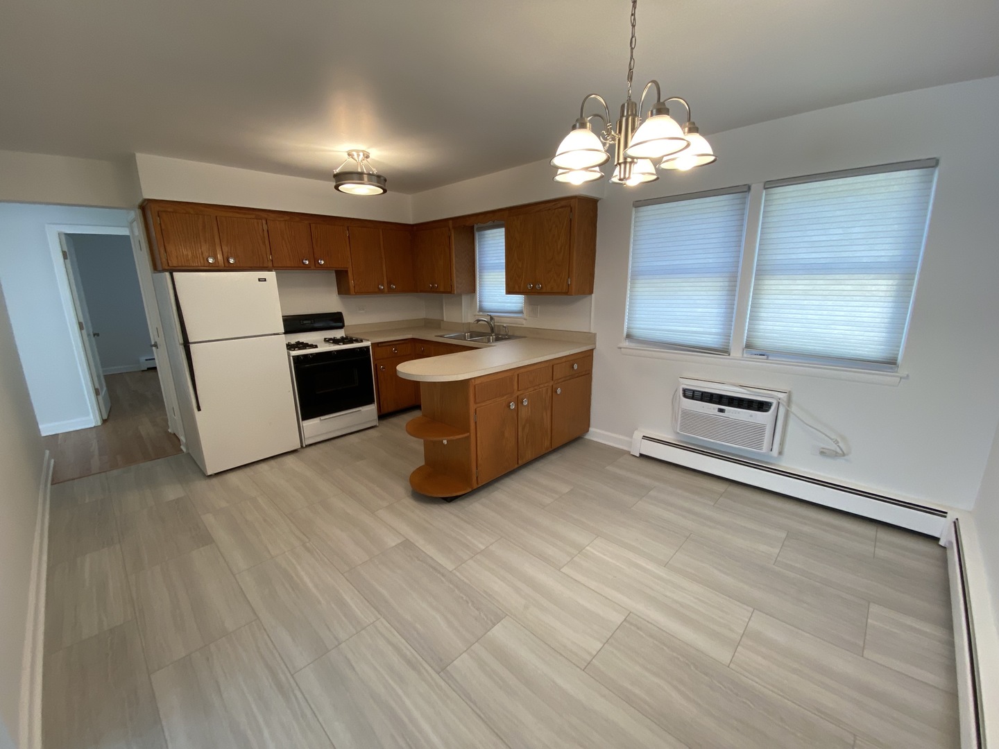 3146 Ridgeland Avenue, Unit 3W Berwyn, IL 60402 - Photo 11 of 16 a kitchen with stainless steel appliances granite countertop a sink a microwave oven a refrigerator and white cabinets