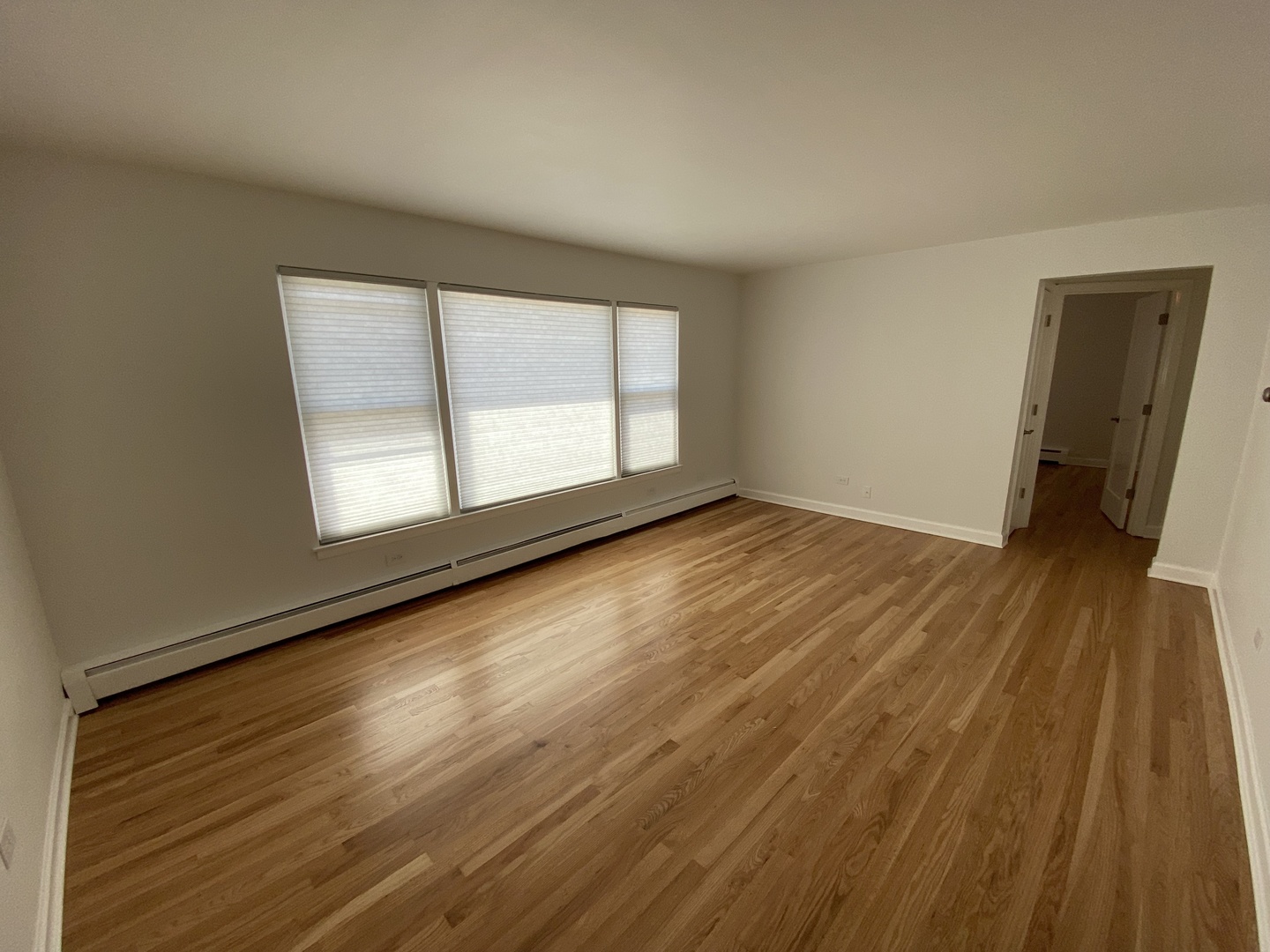 3146 Ridgeland Avenue, Unit 3W Berwyn, IL 60402 - Photo 3 of 16 a view of an empty room with wooden floor and a window