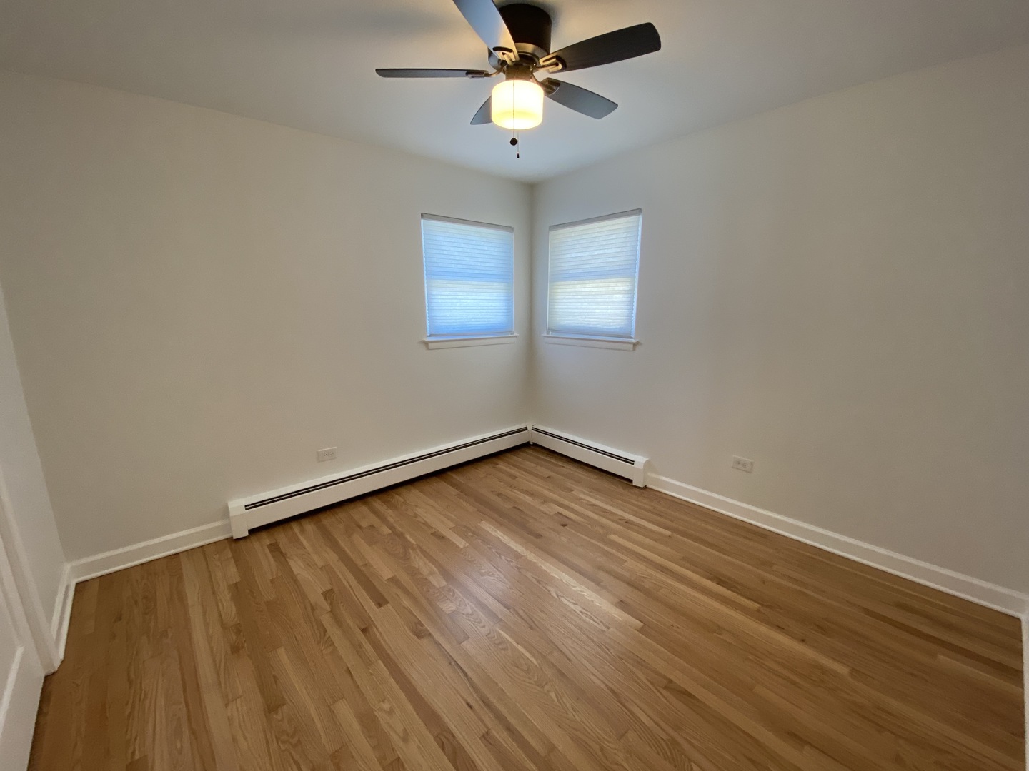 3146 Ridgeland Avenue, Unit 3W Berwyn, IL 60402 - Photo 7 of 16 wooden floor in an empty room with a window