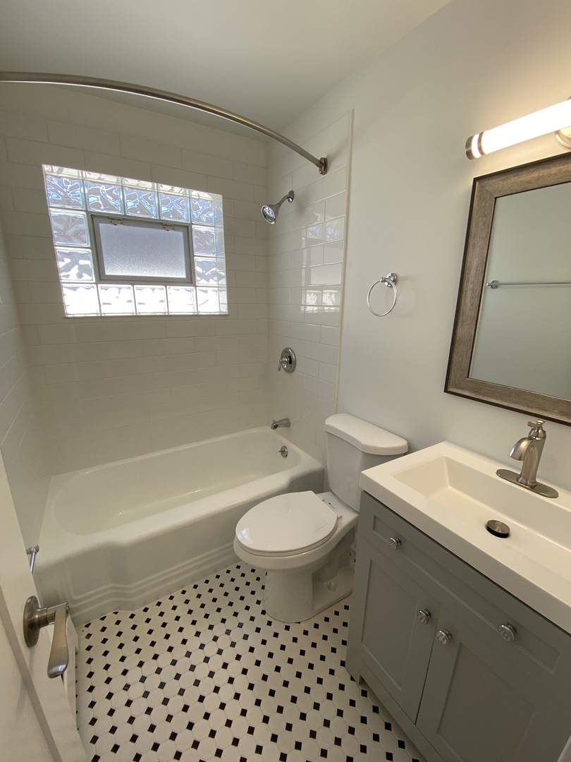 3146 Ridgeland Avenue, Unit 3W Berwyn, IL 60402 - Photo 10 of 16 a bathroom with a sink a toilet and shower
