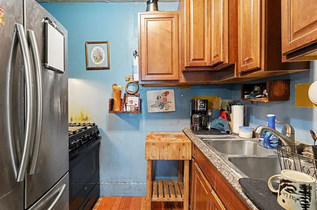 a kitchen with stainless steel appliances granite countertop a refrigerator and a sink