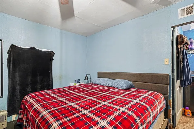 a bedroom with a large bed and a closet