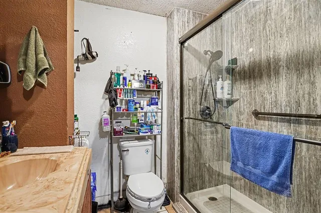 a white toilet sitting next to a bath tub