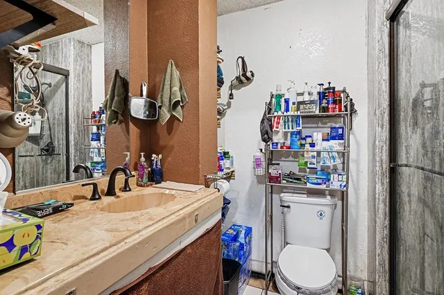 a bathroom with a sink a toilet and a shower curtain