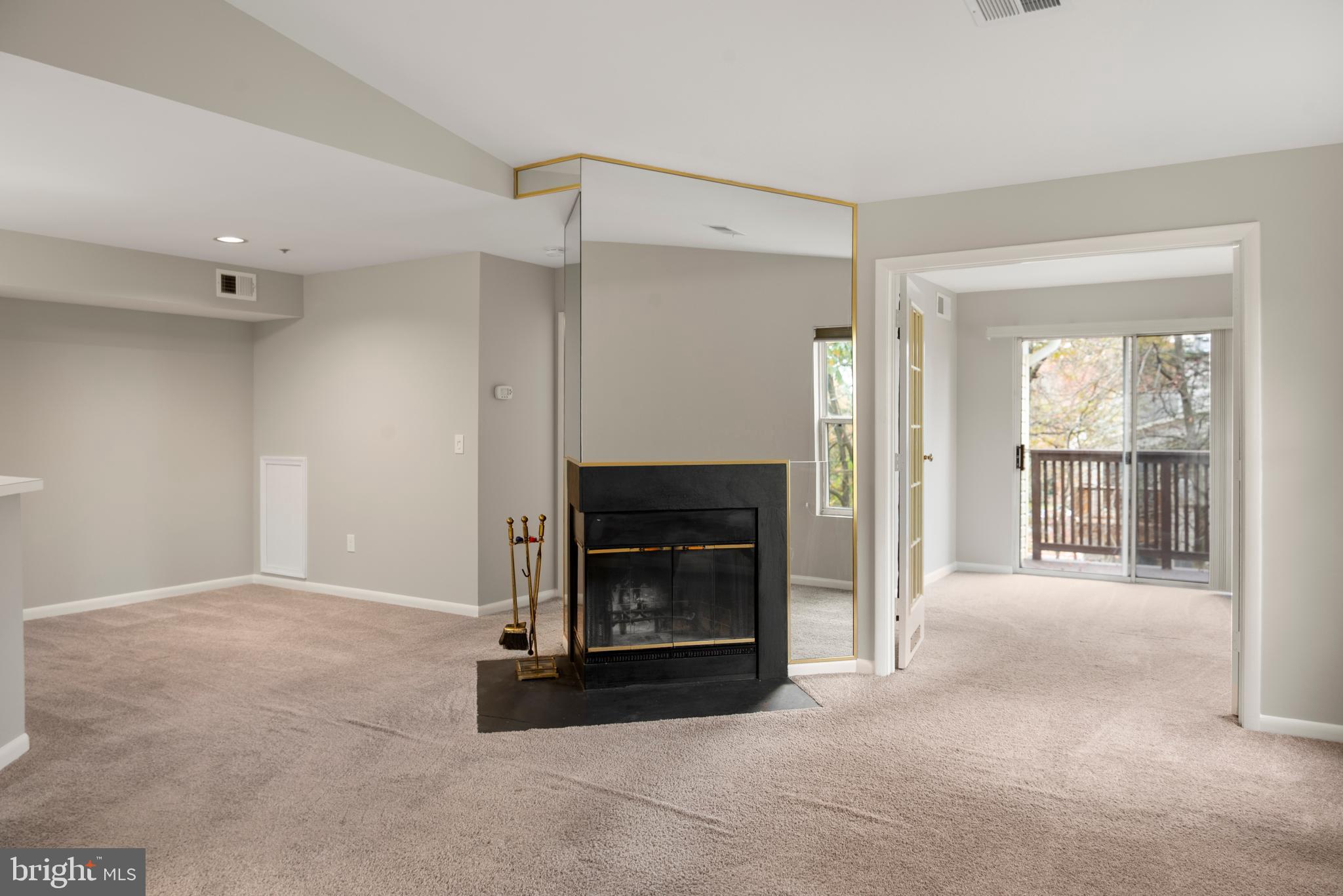 10 L Amberstone Court, Unit L Annapolis, MD 21403 - Photo 14 of 25 a view of an empty room with a fireplace and a window
