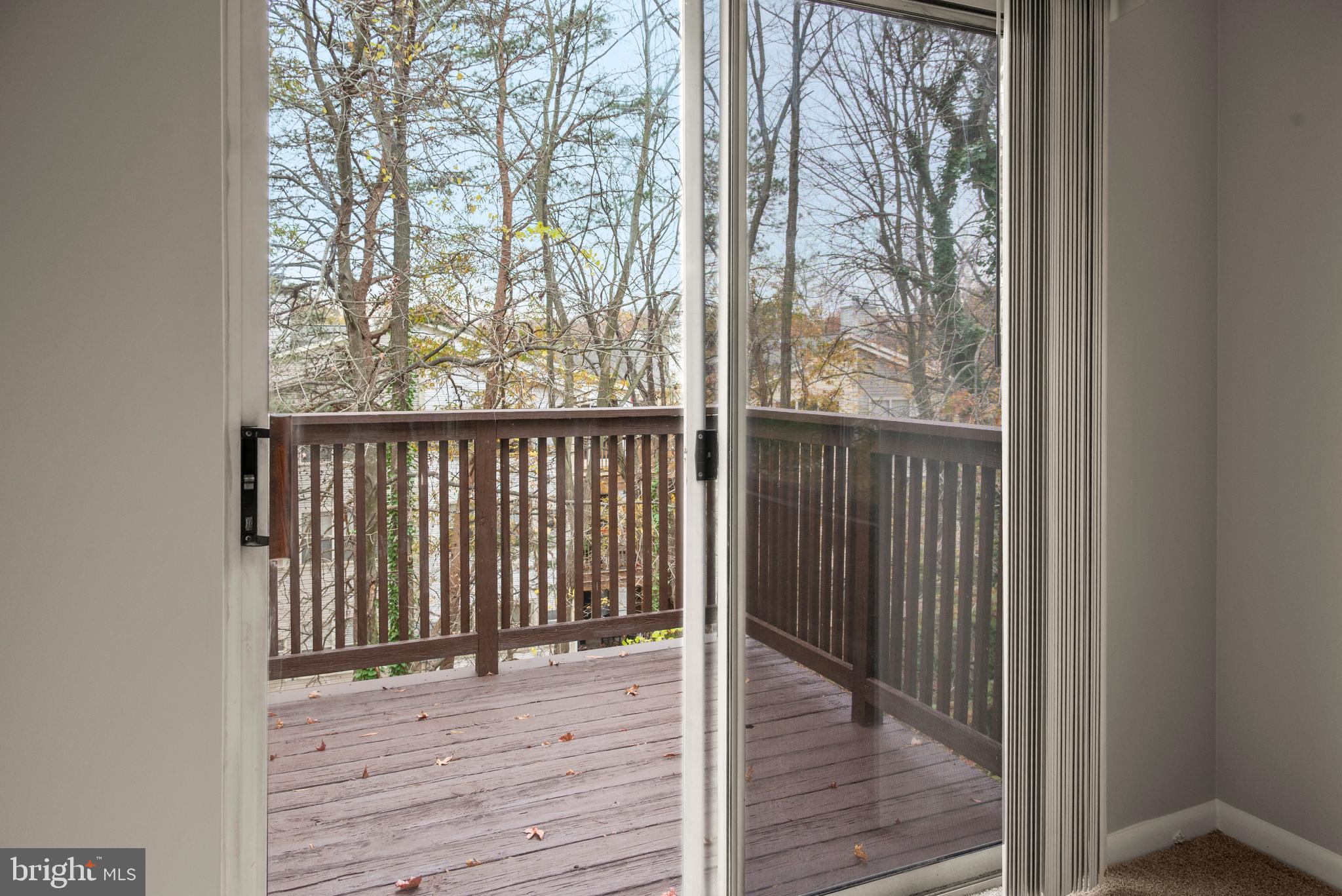 10 L Amberstone Court, Unit L Annapolis, MD 21403 - Photo 25 of 25 a view of a porch with wooden floor and fence