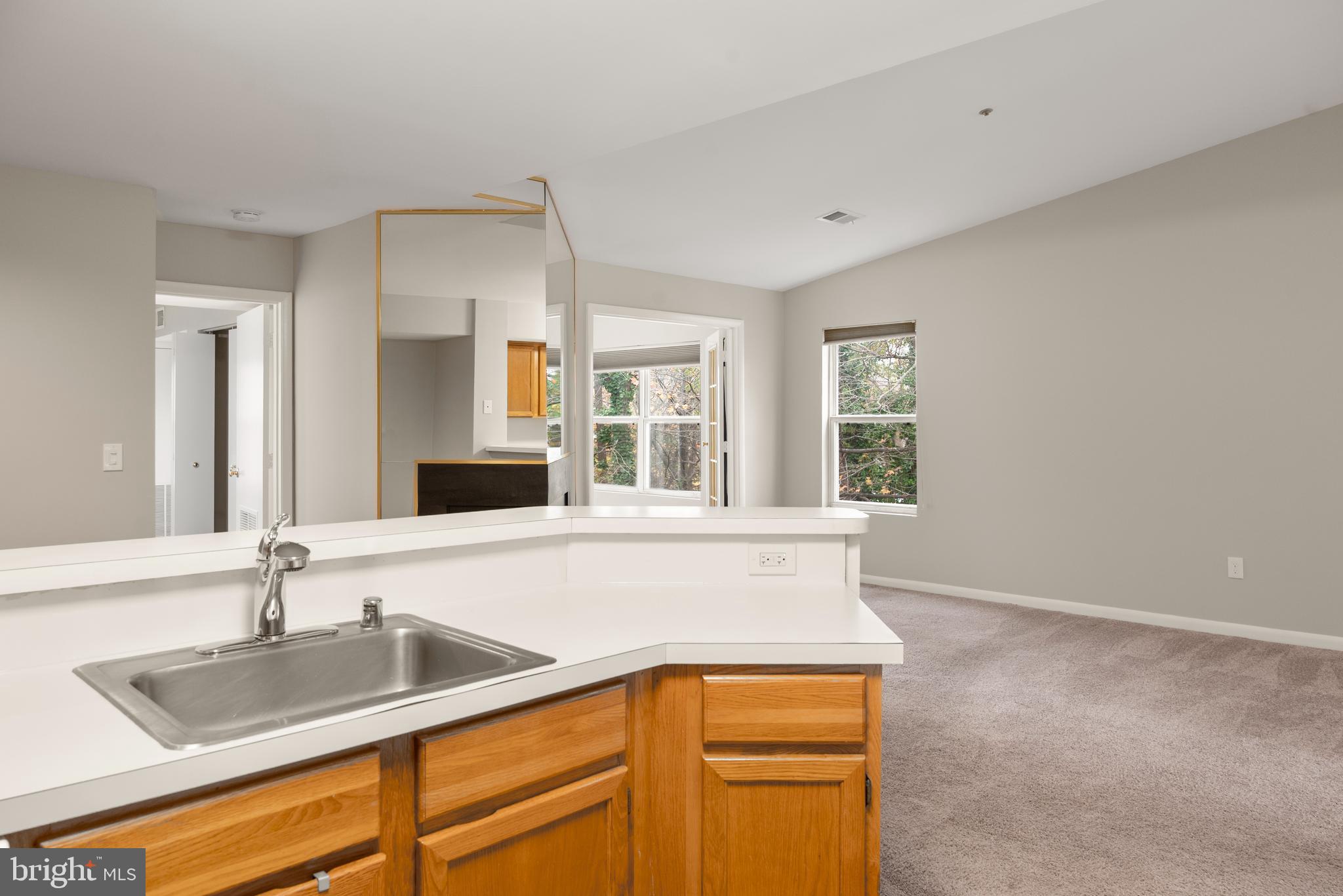 10 L Amberstone Court, Unit L Annapolis, MD 21403 - Photo 9 of 25 a kitchen with granite countertop a sink and a window