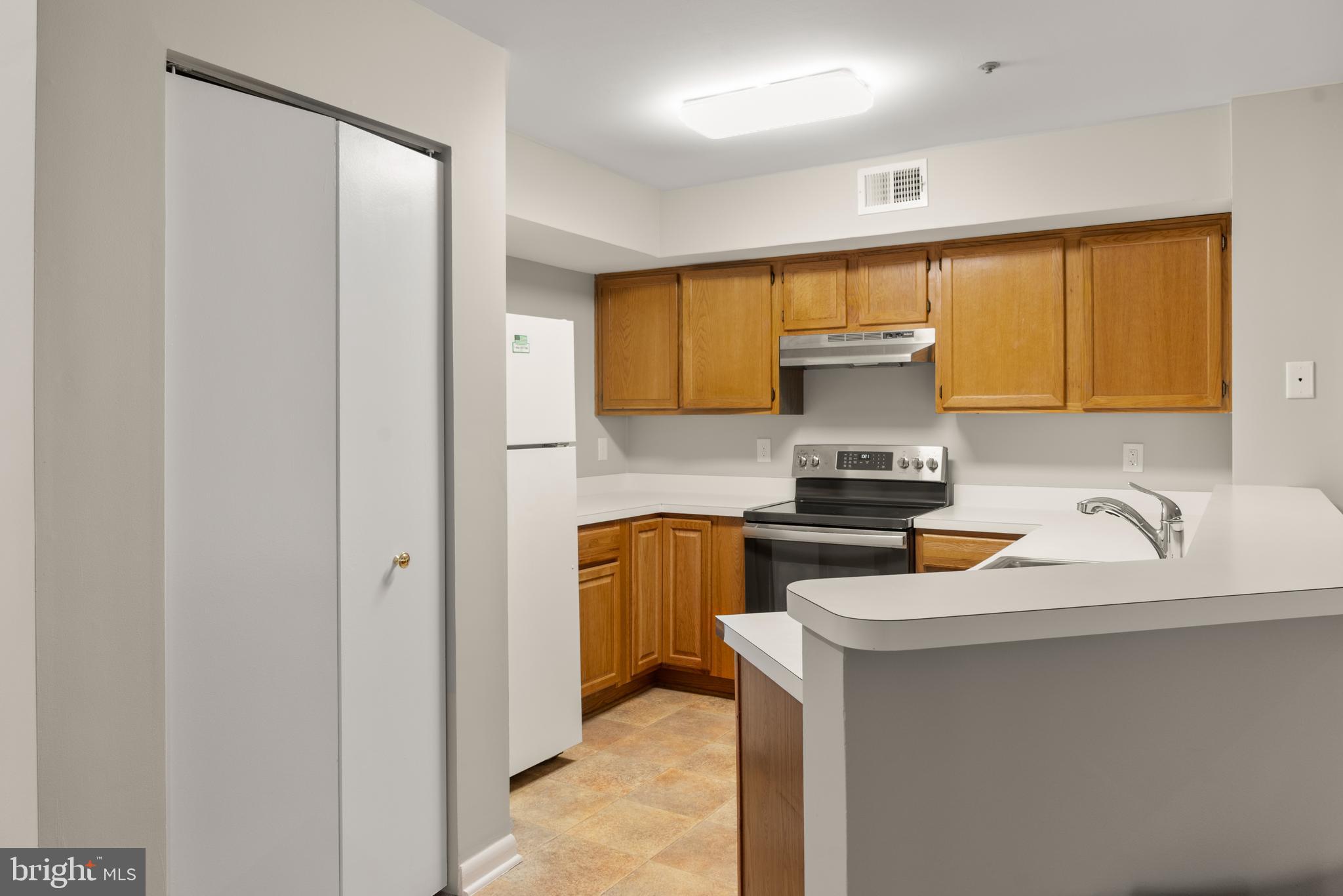 10 L Amberstone Court, Unit L Annapolis, MD 21403 - Photo 10 of 25 a kitchen with a refrigerator and a sink
