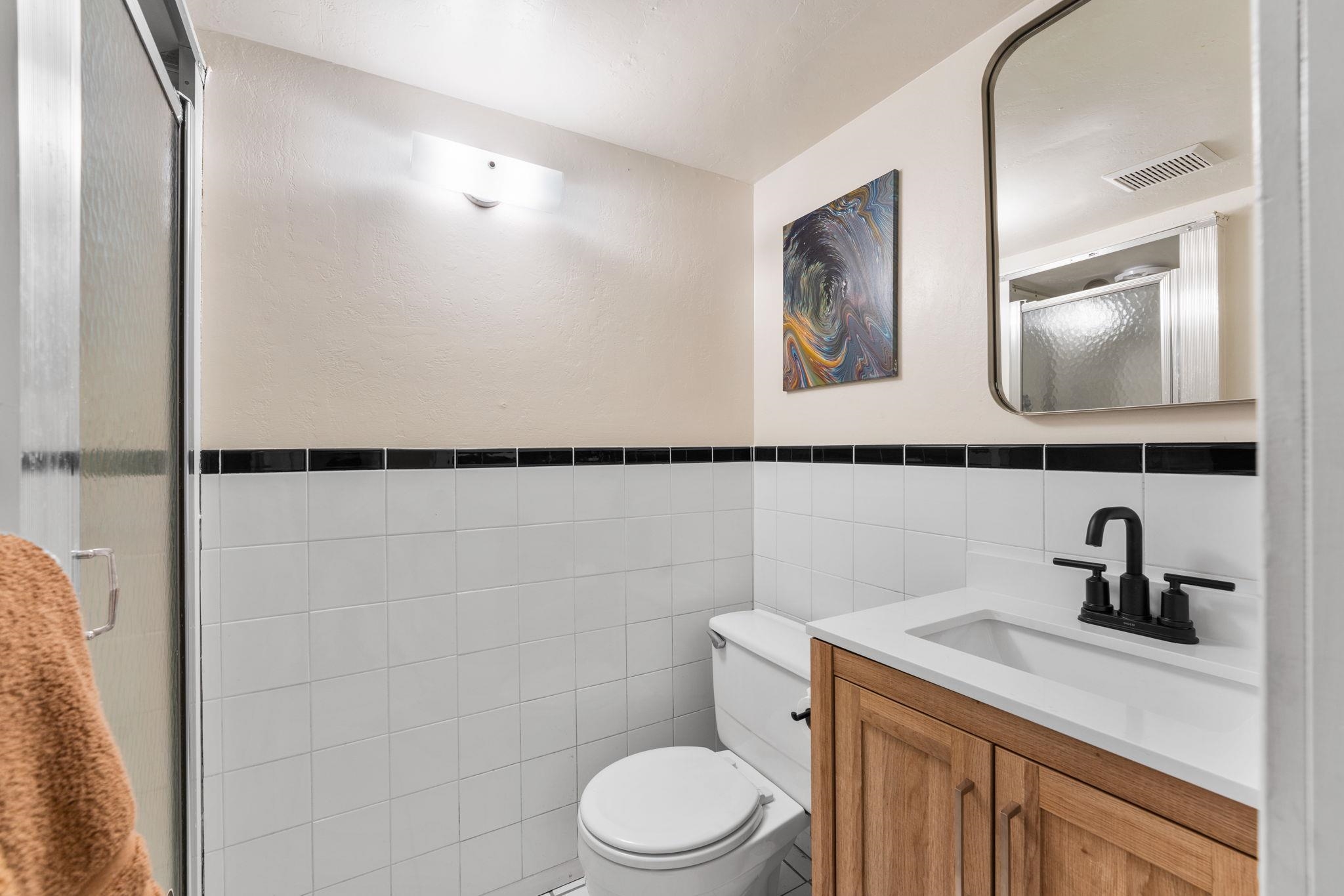 4285 Jeffrey Way Carnelian Bay, CA 96140 - Photo 18 of 21 a bathroom with a toilet a sink and mirror
