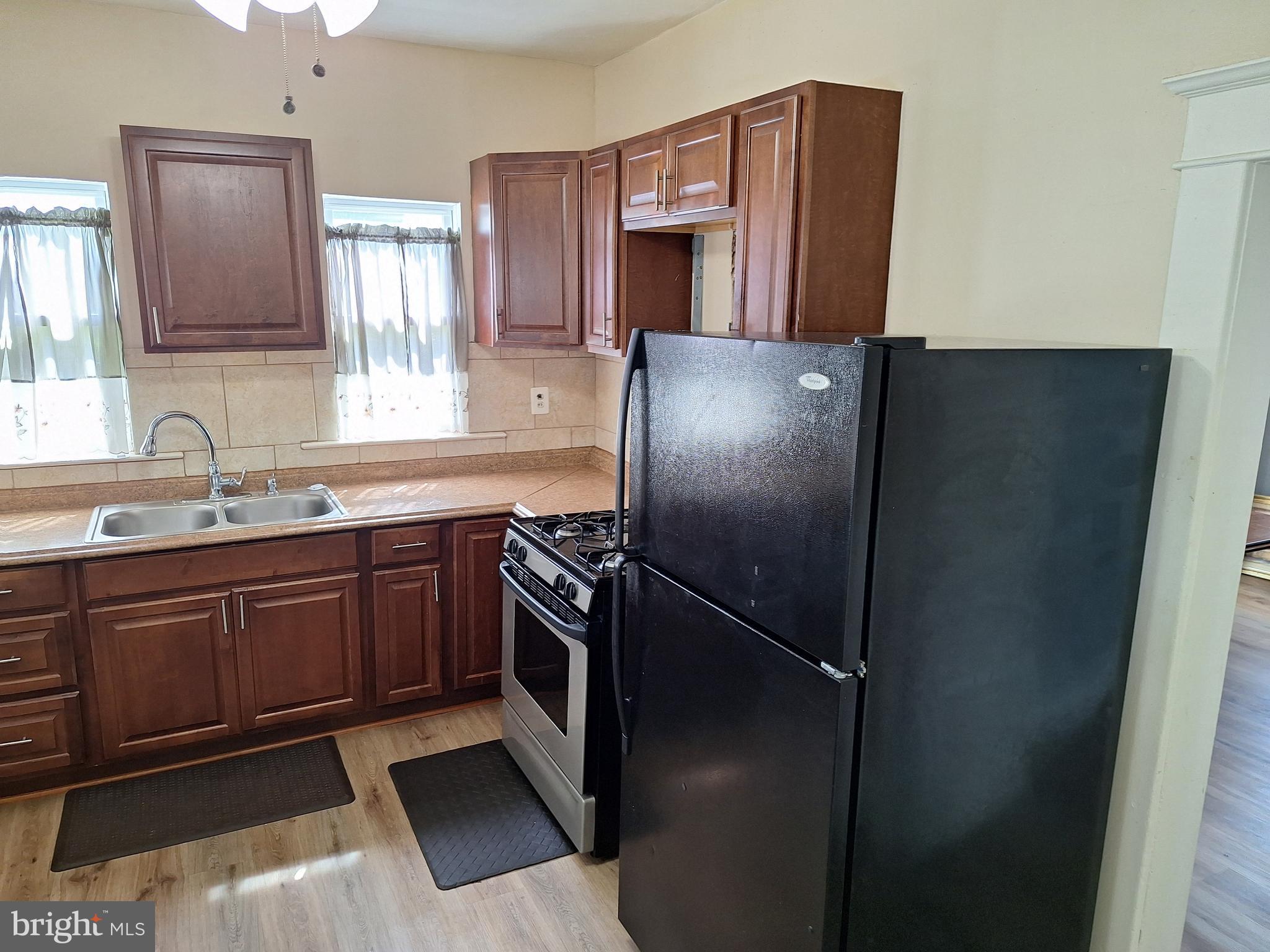 3803 Cedardale Road Baltimore, MD 21215 - Photo 26 of 56 a kitchen with stainless steel appliances granite countertop a refrigerator and a sink