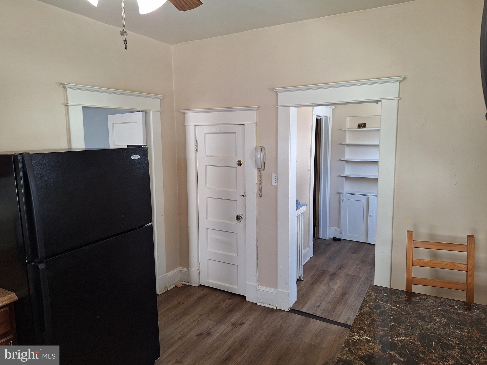 3803 Cedardale Road Baltimore, MD 21215 - Photo 28 of 56 a view of a kitchen from the hallway with wooden floor