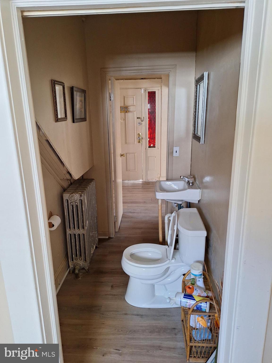 3803 Cedardale Road Baltimore, MD 21215 - Photo 30 of 56 a bathroom with a sink toilet and a mirror