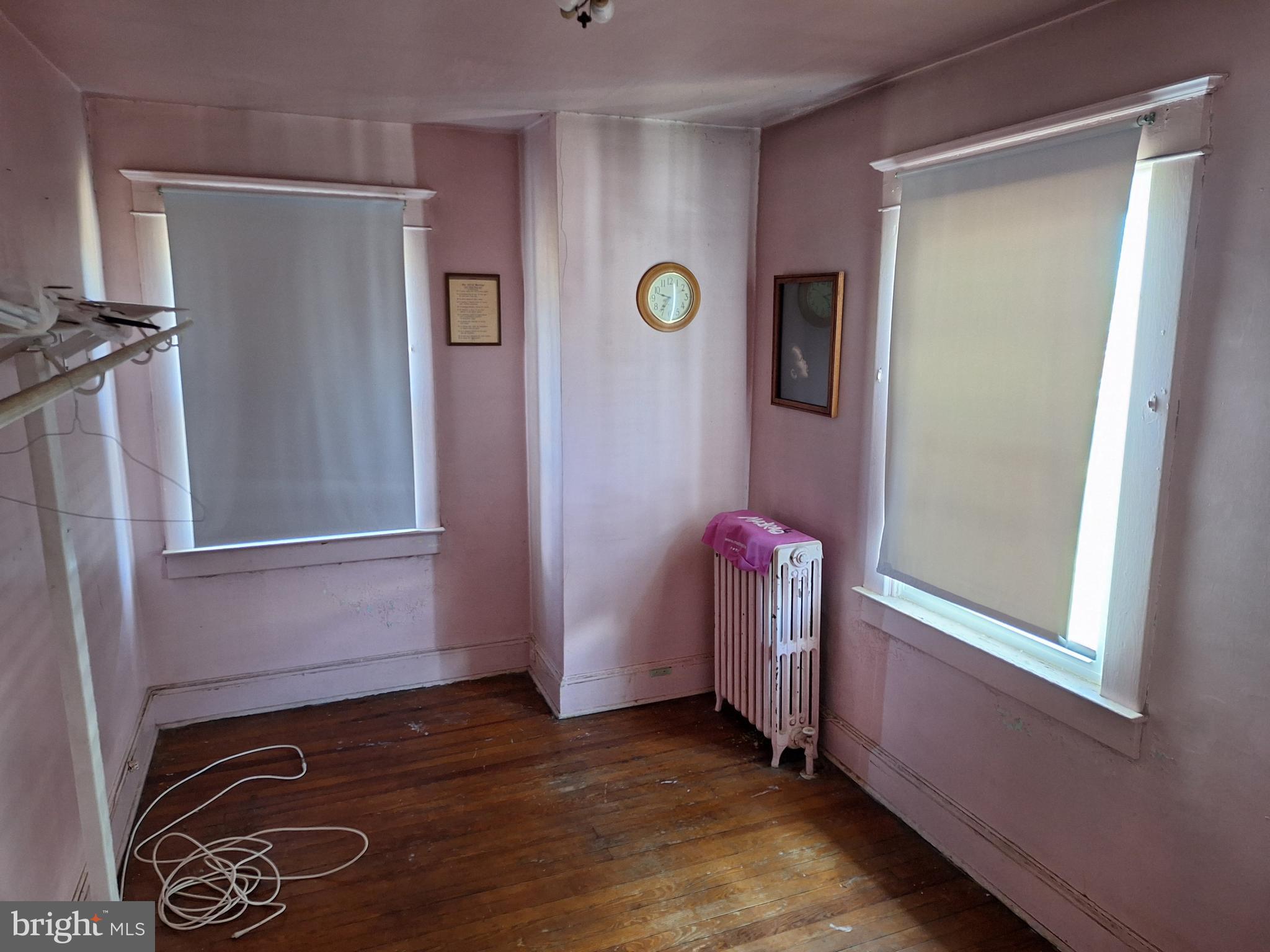 3803 Cedardale Road Baltimore, MD 21215 - Photo 33 of 56 a view of an empty room with wooden floor and a window