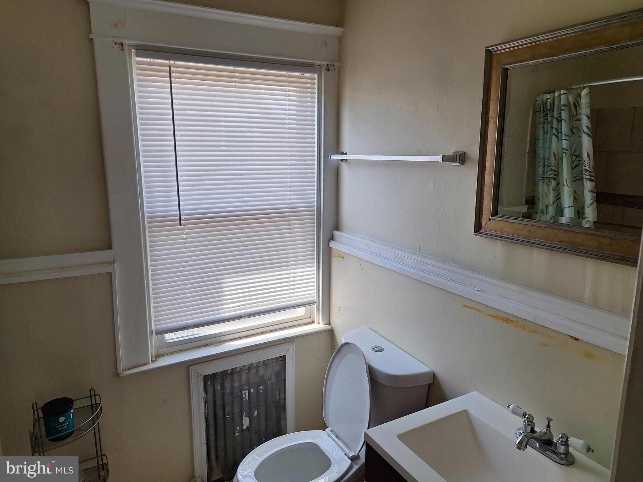 3803 Cedardale Road Baltimore, MD 21215 - Photo 38 of 56 a bathroom with a sink and a mirror