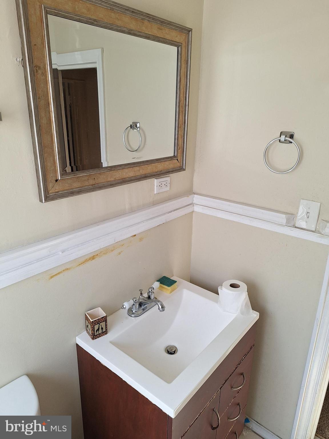 3803 Cedardale Road Baltimore, MD 21215 - Photo 39 of 56 a bathroom with a sink and a mirror