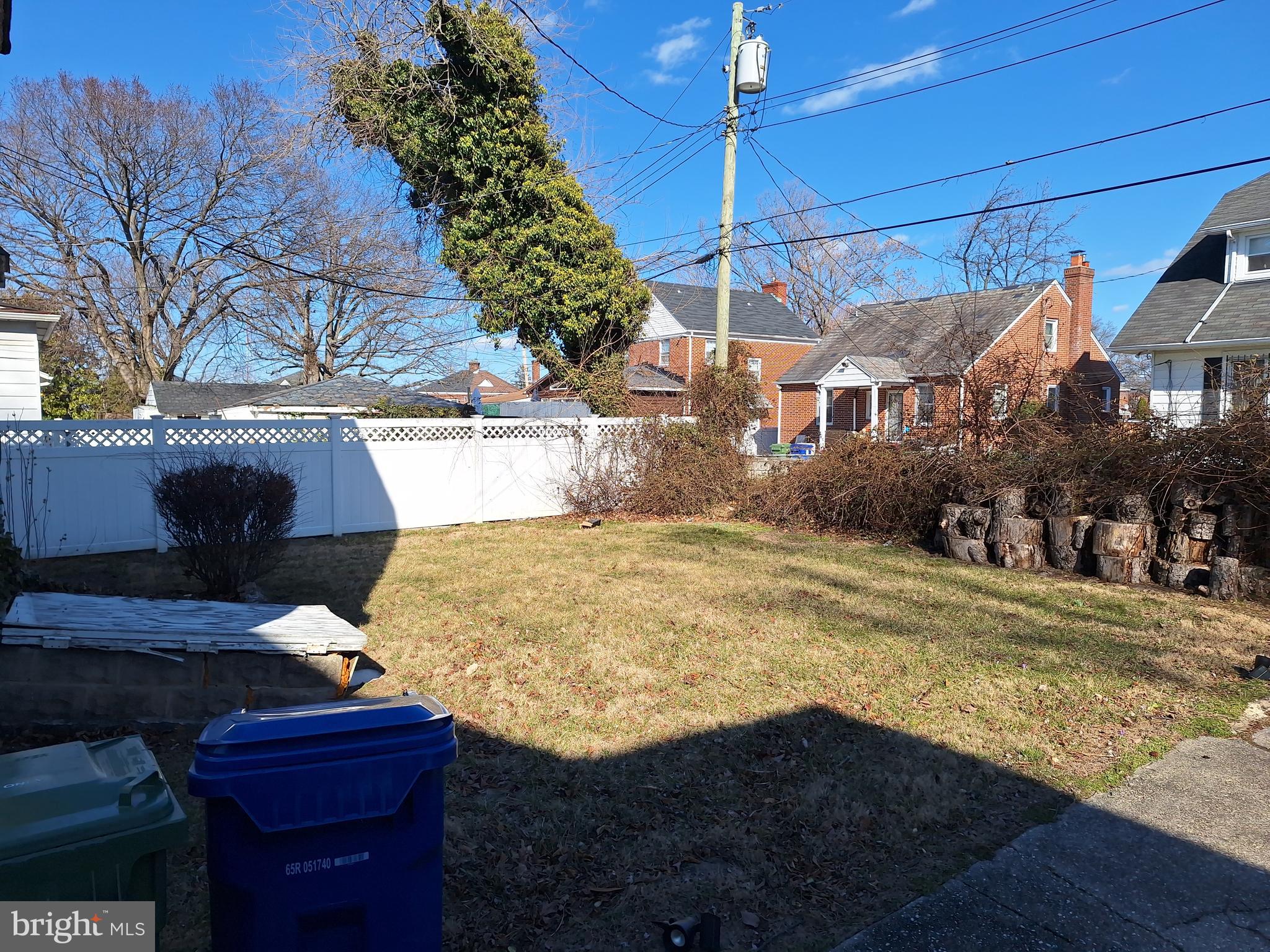 3803 Cedardale Road Baltimore, MD 21215 - Photo 10 of 56 a view of a backyard with brick wall and potted plants