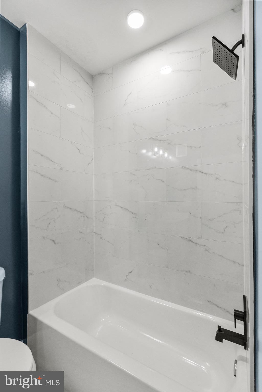 2019 M Street Northeast, Unit 1 Washington, DC 20002 - Photo 16 of 31 a bathroom with a bathtub and shower