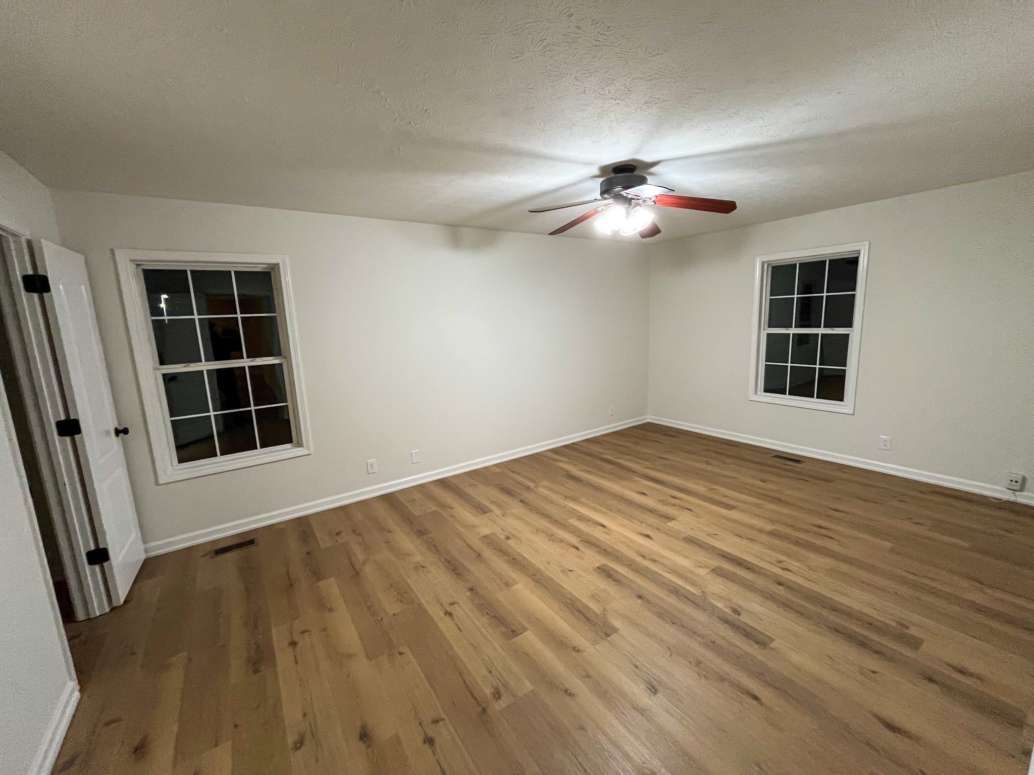 1905 Highway 259 Portland, TN 37148 - Photo 13 of 20 a view of empty room with wooden floor and fan