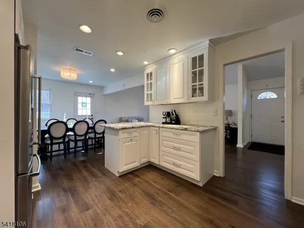 a very nice looking living room with wooden floor and furniture