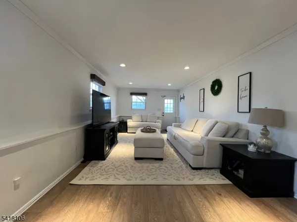 a living room with furniture fireplace and wooden floor