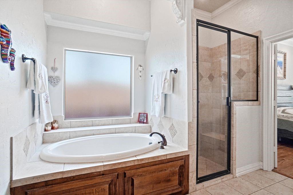 620 Highview Lane Hurst, TX 76054 - Photo 28 of 40 a bathroom with a bathtub and a shower