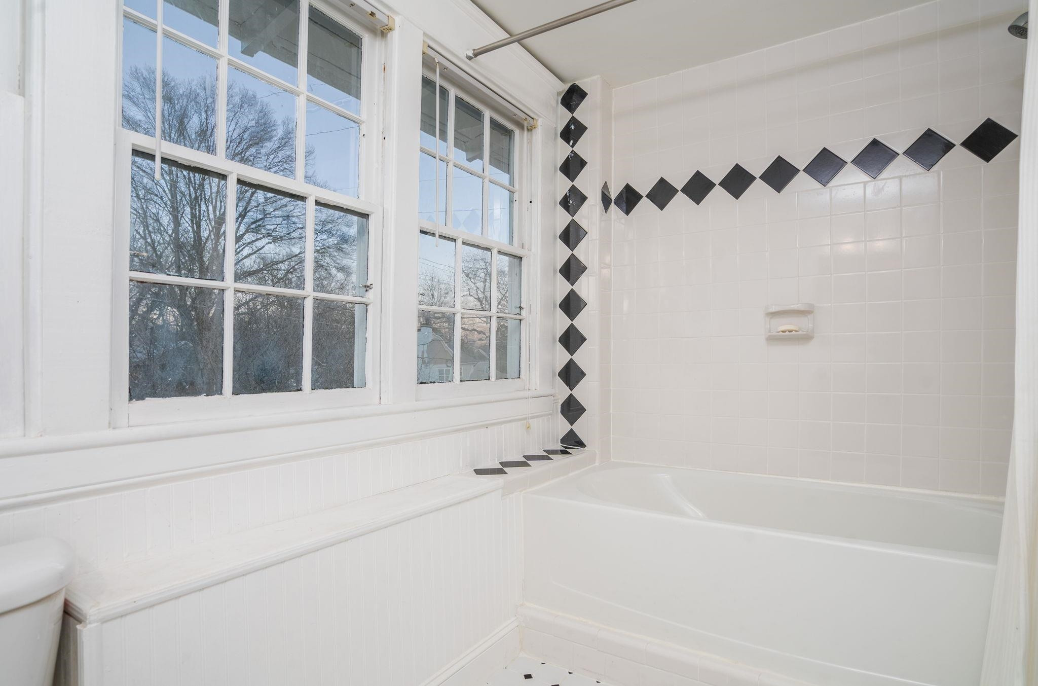 330 Pershing Road Raleigh, NC 27608 - Photo 28 of 51 Tile flooring and tile surround in the tub/shower combination complete the finishes in this bright room, which is full of natural light. Full Bath on 2nd Floor