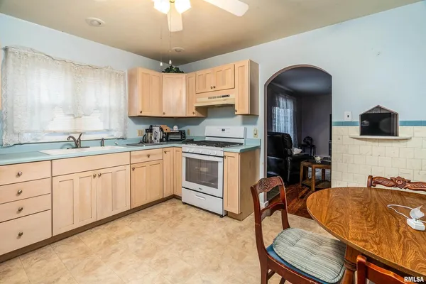 a kitchen with sink cabinets and window