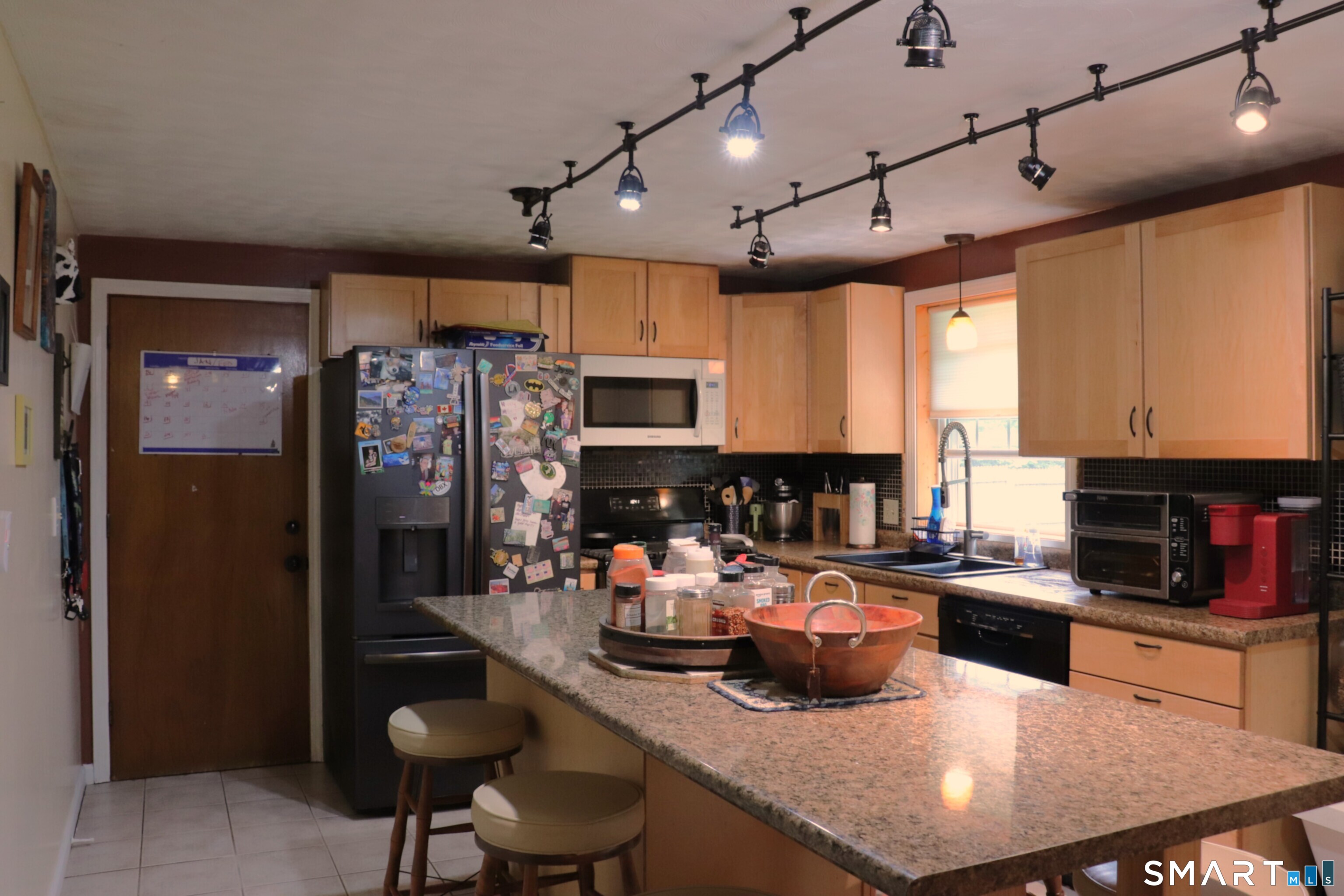 308 Abbe Road Enfield, CT 06082 - Photo 12 of 33 a kitchen with granite countertop a table chairs microwave and cabinets