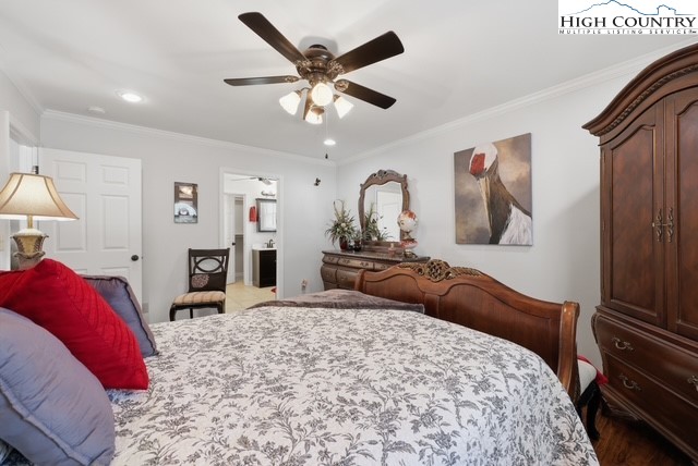 154 Beau Rivage Drive Crumpler, NC 28617 - Photo 14 of 34 a bedroom with a large bed and a chandelier