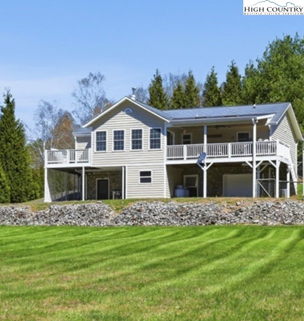 154 Beau Rivage Drive Crumpler, NC 28617 - Photo 16 of 34 a front view of a house with a garden