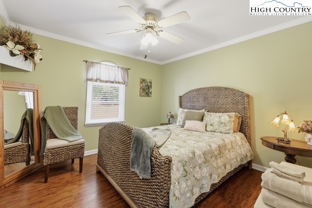 154 Beau Rivage Drive Crumpler, NC 28617 - Photo 17 of 34 a bedroom with a bed and wooden floor