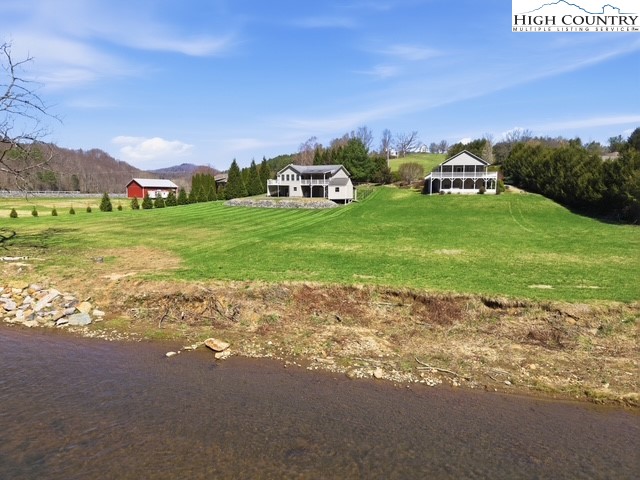 154 Beau Rivage Drive Crumpler, NC 28617 - Photo 19 of 34 a front view of a house with garden