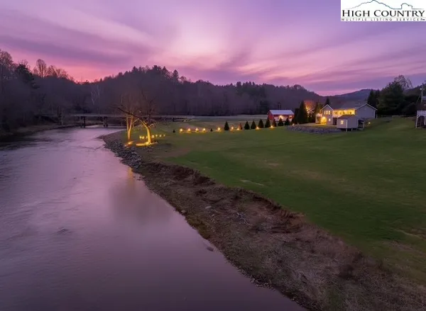 a view of a lake with sunset in background