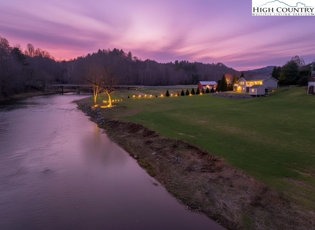 154 Beau Rivage Drive Crumpler, NC 28617 - Photo 2 of 34 a view of a lake with sunset in background