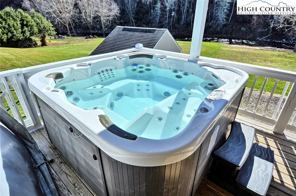 a view of a patio with lawn chairs next to a yard