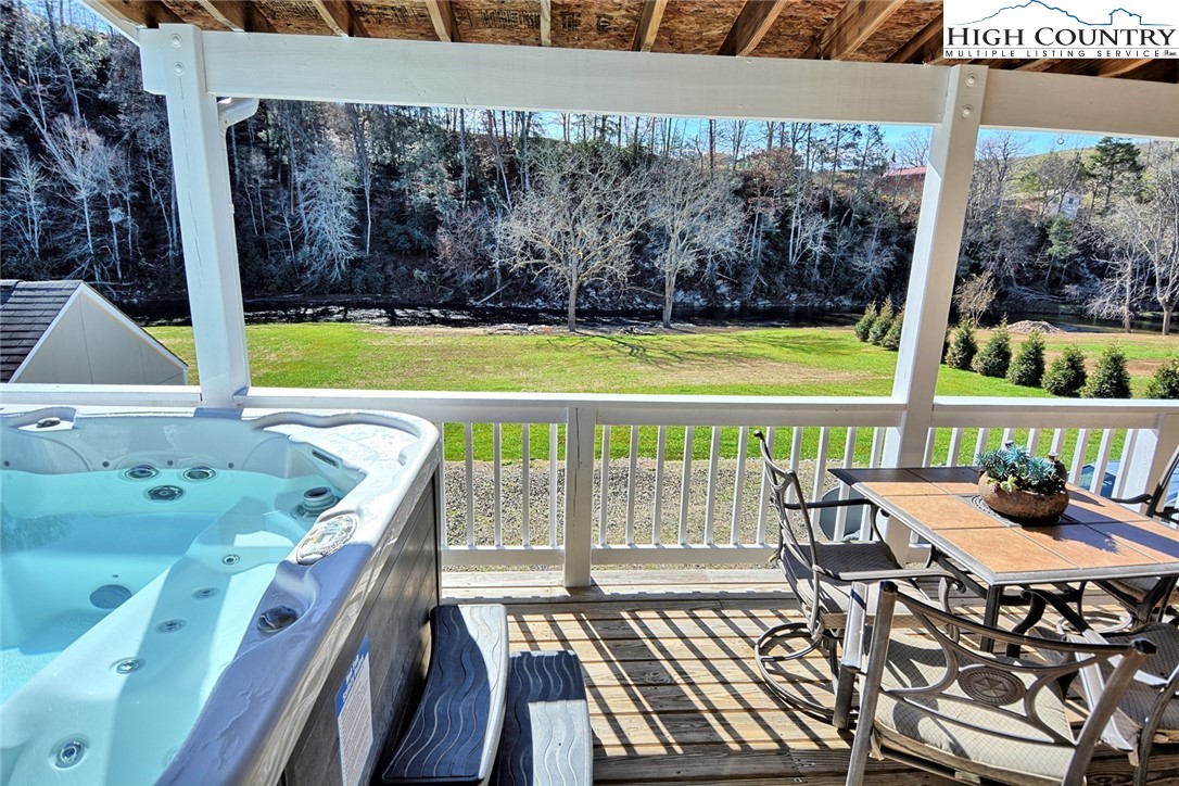 154 Beau Rivage Drive Crumpler, NC 28617 - Photo 23 of 34 a view of a patio with lawn chairs next to a yard