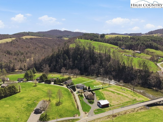 154 Beau Rivage Drive Crumpler, NC 28617 - Photo 32 of 34 a view of a backyard with plants and mountains